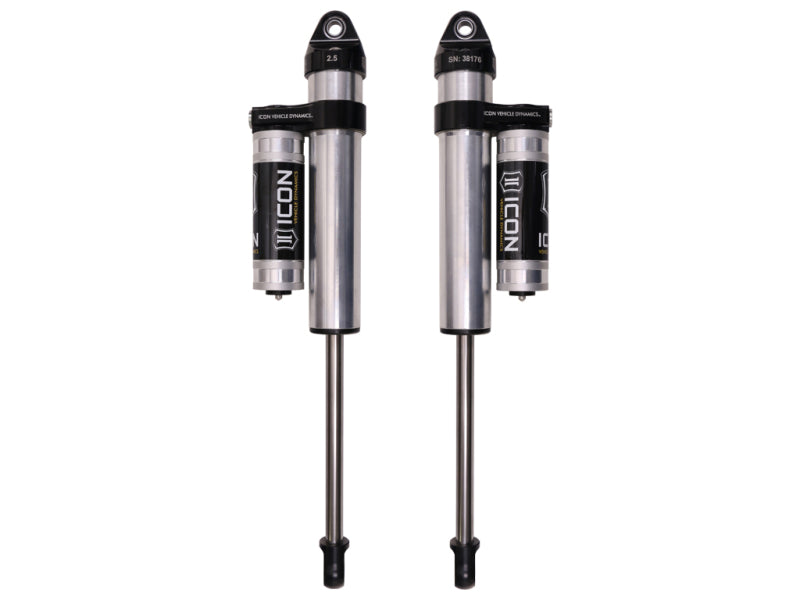 Two ICON 09-18 Ram 1500 0-3in Rear 2.5 Series Shocks VS PB - Pair are shown against a white background. Each shock absorber features a silver body with black accents and a logo displaying the text "ICON." The shocks vary in length and come with attached reservoirs, ensuring a smooth ride and enhanced off-road performance.