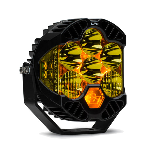 A close-up of the Baja Designs LP6 Pro Driving/Combo LED - Amber, a round black off-road light with six hexagonal amber lenses, showcases its rugged design. It features a sturdy bracket and delivers bright, versatile lighting in challenging conditions.