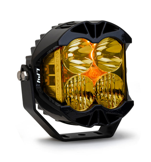 The Baja Designs LP4 Pro Driving/Combo LED - Amber is a round, black off-road LED light featuring a sturdy housing and four amber lenses. It is mounted on an adjustable bracket, with intricate patterns on its reflective surfaces that enhance its rugged and high-performance appearance, making it ideal for driving/combo LED applications.