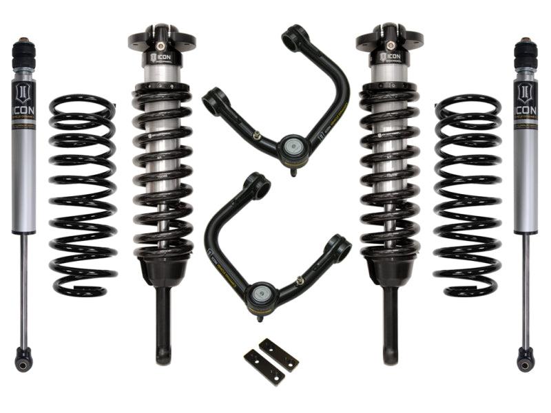 The image showcases the ICON 03-09 Toyota 4Runner/FJ 0-3.5in Stage 2 Suspension System w/Tubular Uca. It includes two coilover shock absorbers with springs, two standalone springs, ICON tubular upper control arms with Delta Joints for enhanced durability, and two small metallic brackets. All components are arranged neatly against a white background for easy viewing.