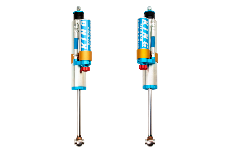 Two King Shocks 2005+ Ford F-250 4WD Front 2.5 Dia Remote Reservoir Shock w/Adj for 1-2.5in Lift (Pair) with blue anodized finish, gold accents, and red adjusters. They are positioned vertically, showcasing their robust build designed for high-performance off-road suspension systems and OEM Performance Upgrade Kits.