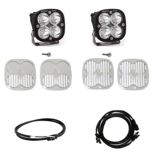 An image showcasing the Baja Designs 2021+ Ford Bronco A Piller Light Kit Squadron Sport Spot w/Upfitter, which includes two LED lights with four lenses each, mounting screws, four protective light covers (two featuring a crisscross pattern and two with a grid pattern), and two sets of connection cables.