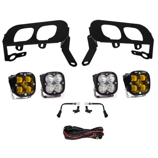 This Baja Designs fog pocket kit for the 2014-2015 Silverado 1500 includes four LED lights with amber lenses, black mounting brackets, wiring harnesses, and connectors, perfectly displayed on a white background. It offers an effortless upgrade to your vehicle's lighting system.