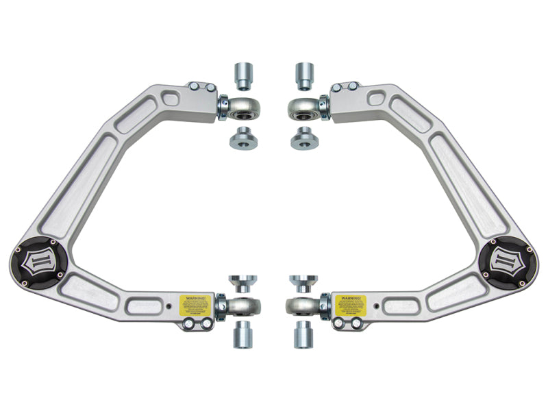 A pair of ICON 2019+ GM 1500 Billet Upper Control Arms with remarkable corrosion resistance, displayed symmetrically on a white background. Each arm features black end caps, adjustable Delta Joints from ICON, and comes with all necessary mounting hardware included.