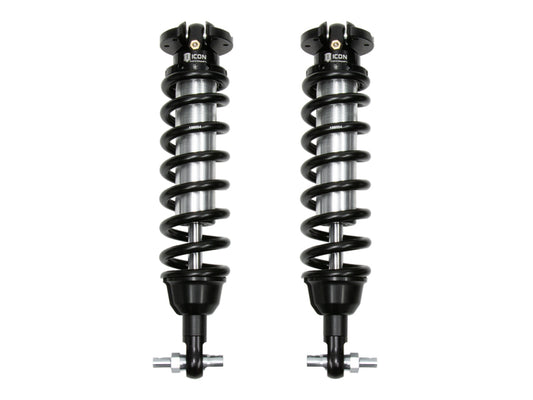 The ICON 2019+ Ford Ranger Ext Travel 2.5 Series Shocks VS IR Coilover Kit showcases two vehicle-specific coilover shocks side by side, each adorned with coiled springs and a sleek metallic finish. These shocks, branded under ICON, feature black top and bottom mounts designed for off-road performance and an exceptionally smooth ride.