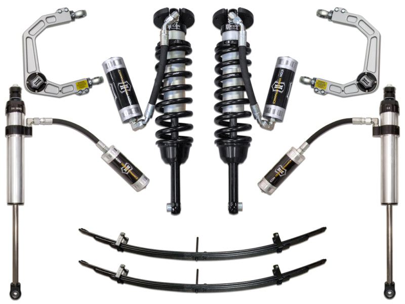 The ICON 05-15 Toyota Tacoma 0-3.5in/2016+ Toyota Tacoma 0-2.75in Stg 5 Suspension System w/Billet UCA by ICON includes a comprehensive suspension kit featuring two coiled shock absorbers, four individual shocks with reservoirs, two leaf springs, and two upper control arms with Delta Joints for enhanced durability. The components are symmetrically arranged on a white background.