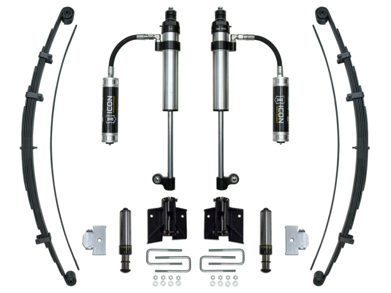 The ICON 2005+ Toyota Tacoma RXT Stage 1 System includes a complete set of vehicle suspension components: two shock absorbers with attached reservoirs, two leaf springs, mounting brackets, and various small hardware pieces such as bolts and washers—all neatly arranged on a white background.